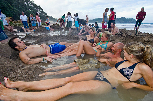 Relaxing at Hot Water Beach in the Coromandel. Image courtesy Tourism Coromandel.
