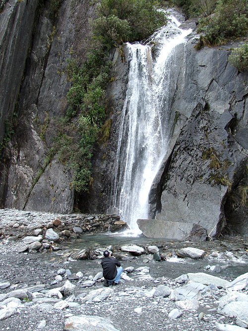 Our son Tim takes a snap of a waterfall on the trail to Franz Josef glacier