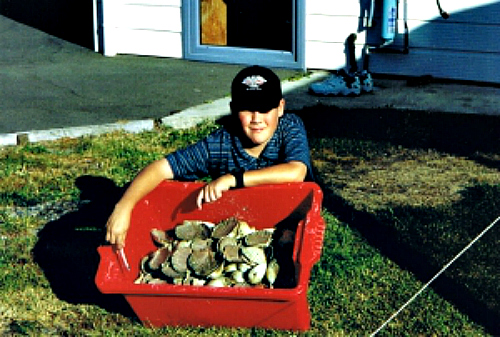 Our son Tim with a catch of fresh scallops